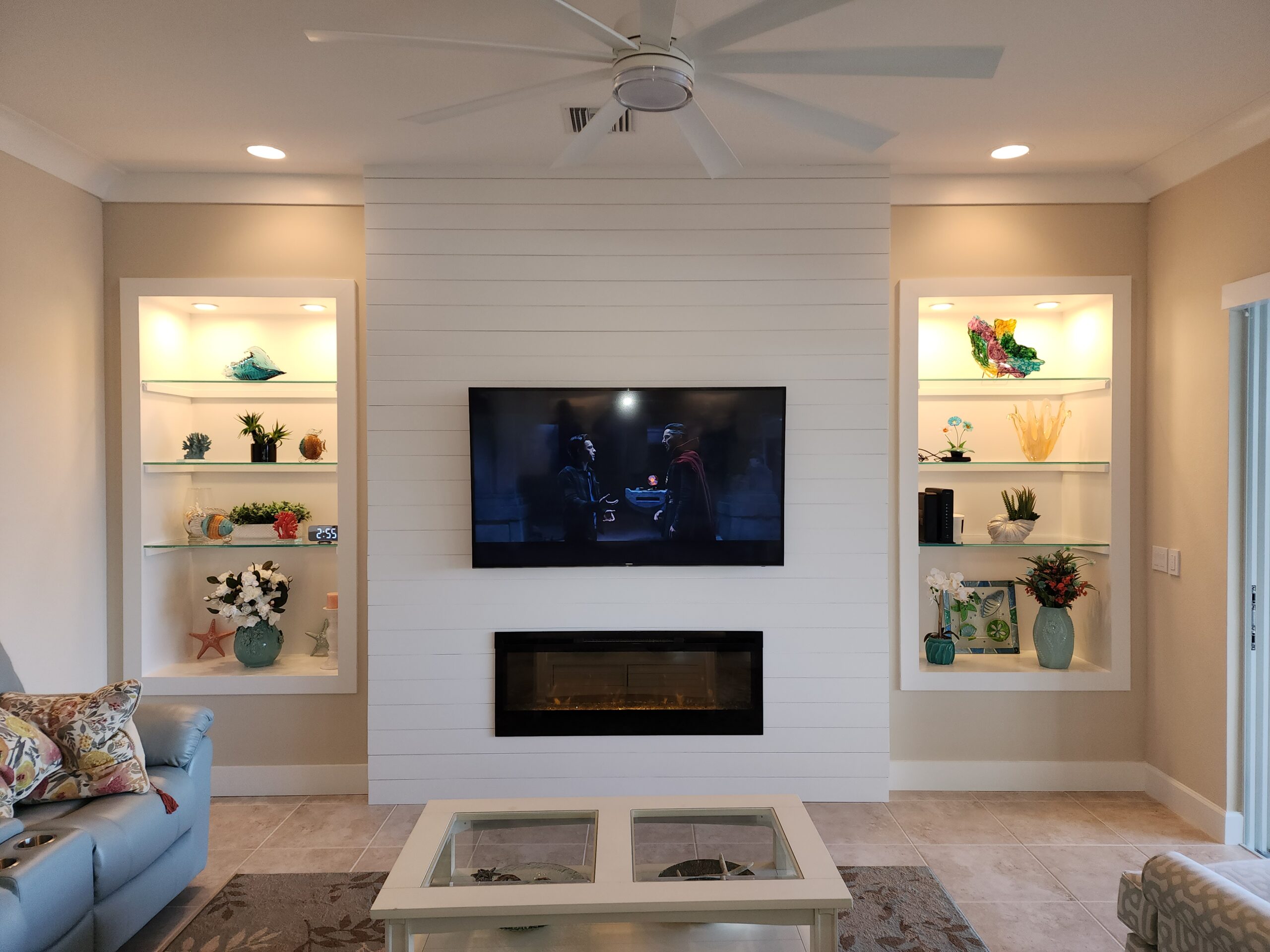 Media wall build in Punta Gorda, featuring updated trim, TV mounting, a custom mantle, and shiplap detailing throughout