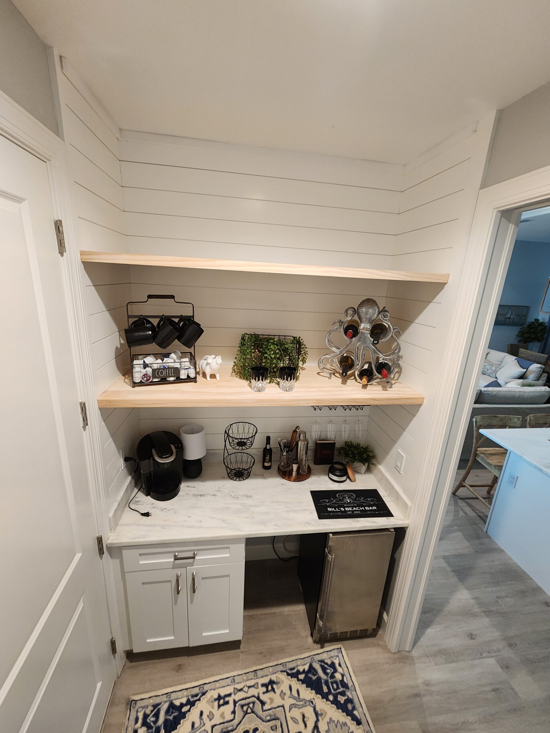 Project for Maria and Bob in Bonita, featuring shiplap, stained shelves, underlit shelves, a stained mantle, and custom cabinets.