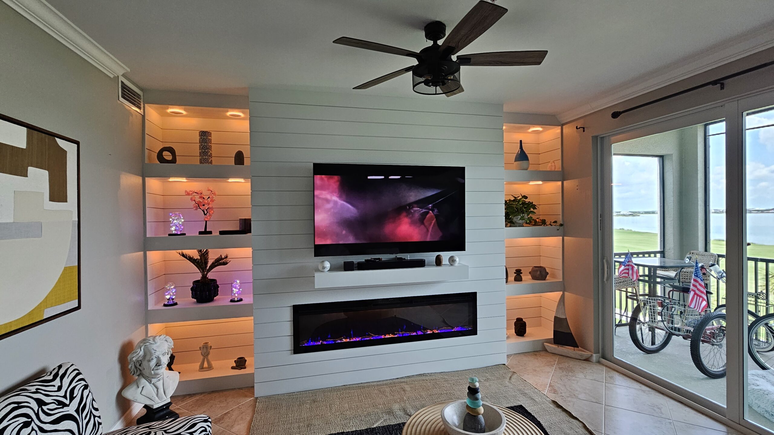 Media wall build for Marie in Babcock Ranch, Punta Gorda, featuring shiplap, a lighted alcove, inset fireplace, and mounted TV.