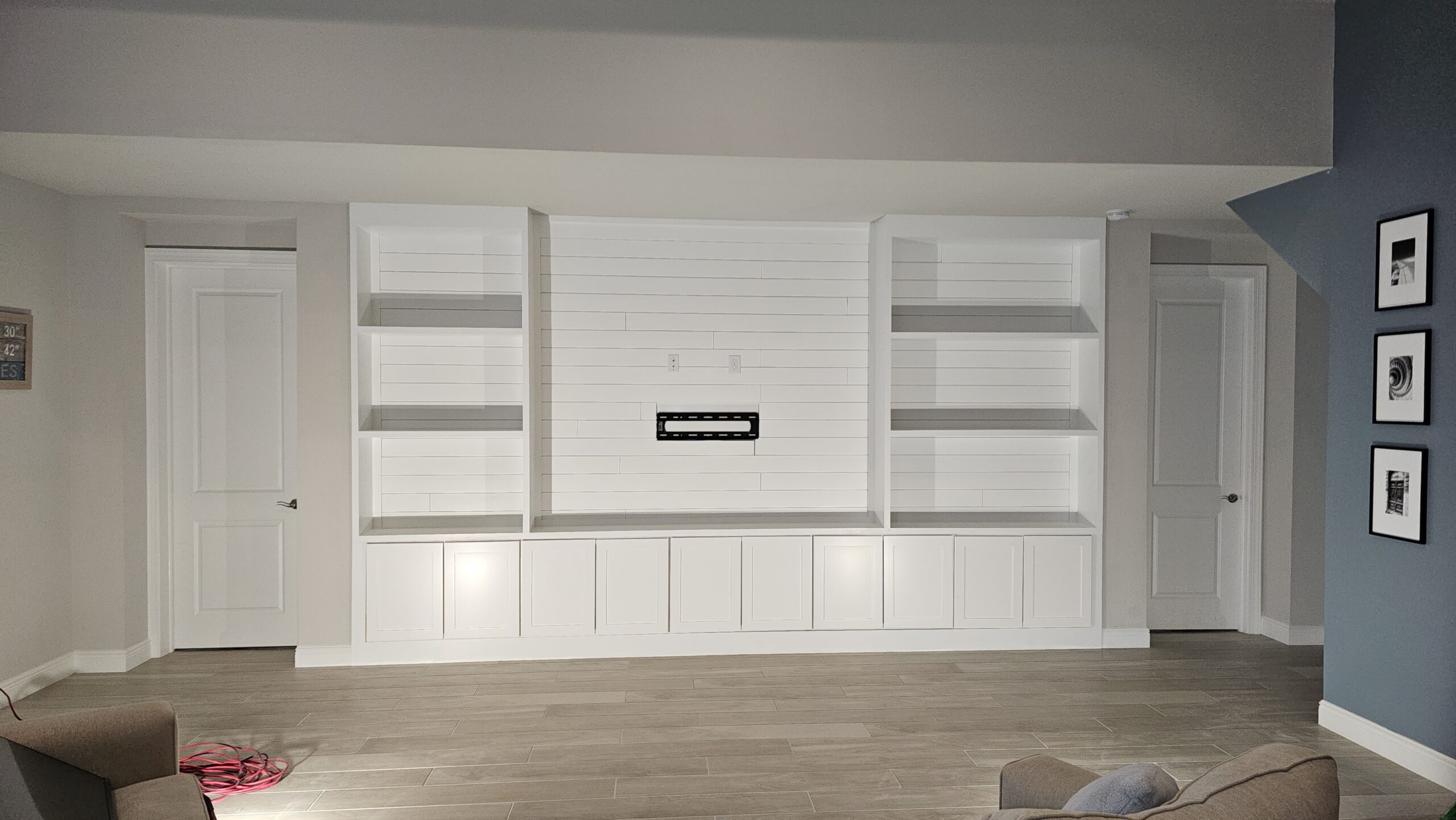 Media wall project for Michelle Marx, featuring shiplap, custom cabinets, and built-in shelves.